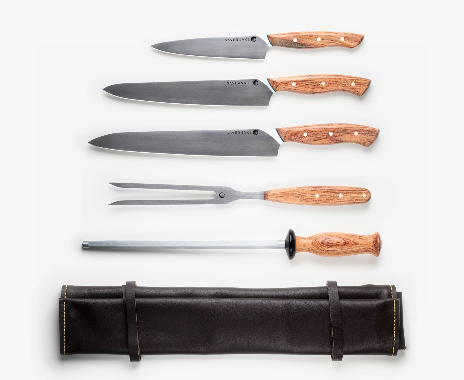 Damascus pattern chef knife blade chopping fresh herbs on dark walnut end-grain cutting board
